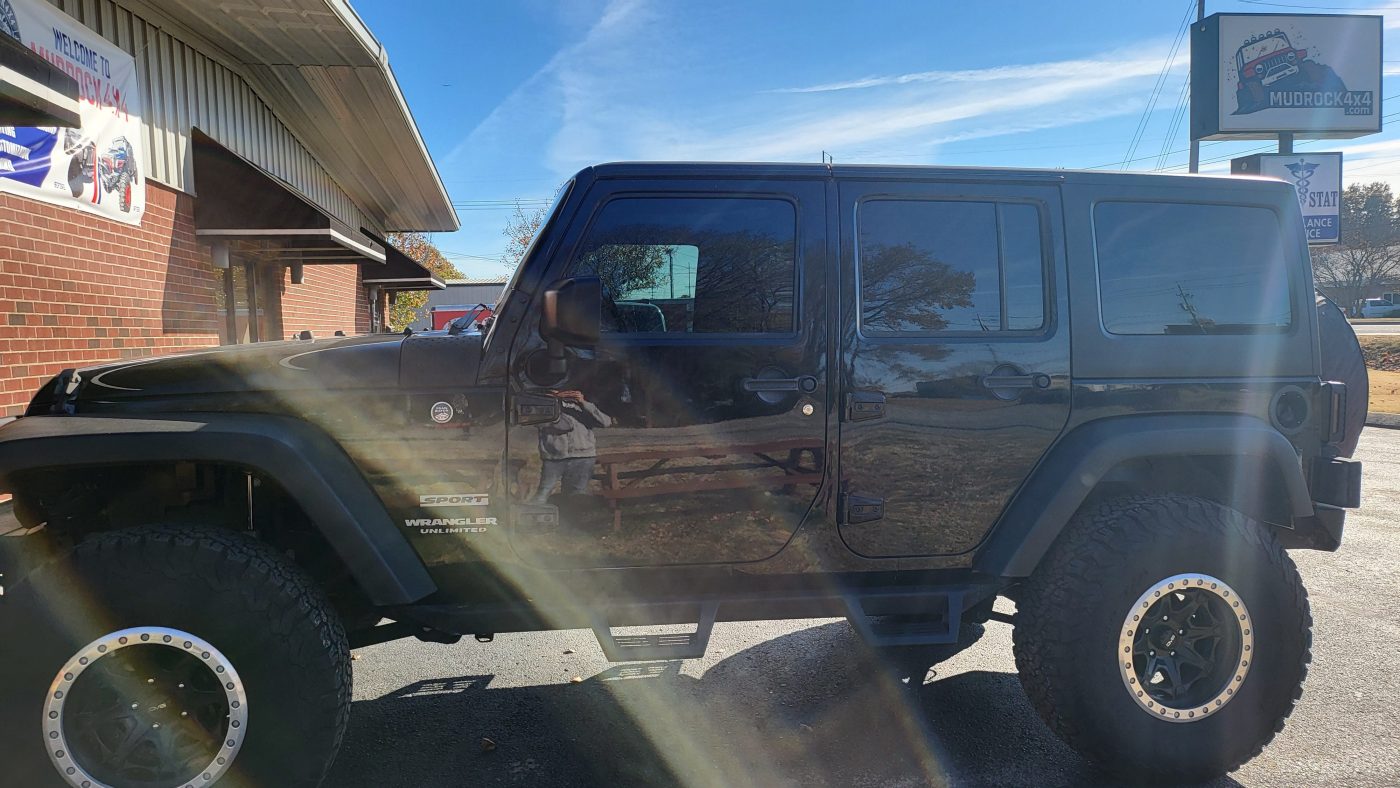 Driver side profile showing lift and side steps